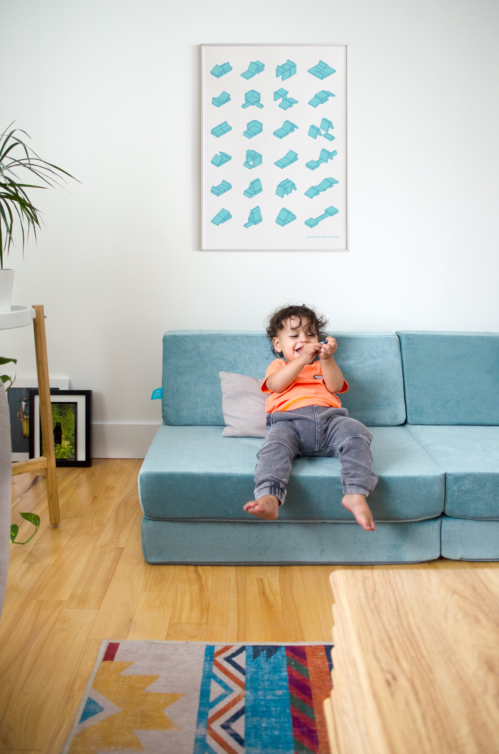 child laughing sitting on a soft foam sofa 