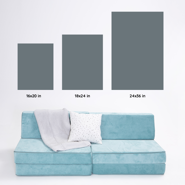 play couch next to different three different sizes of posters